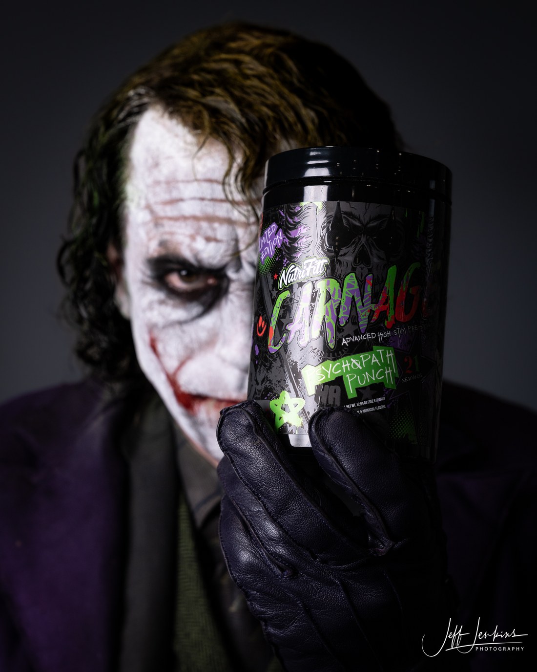 Character portrait with smeared face paint holding a product tub, an example of Jeff Jenkins's commercial character work